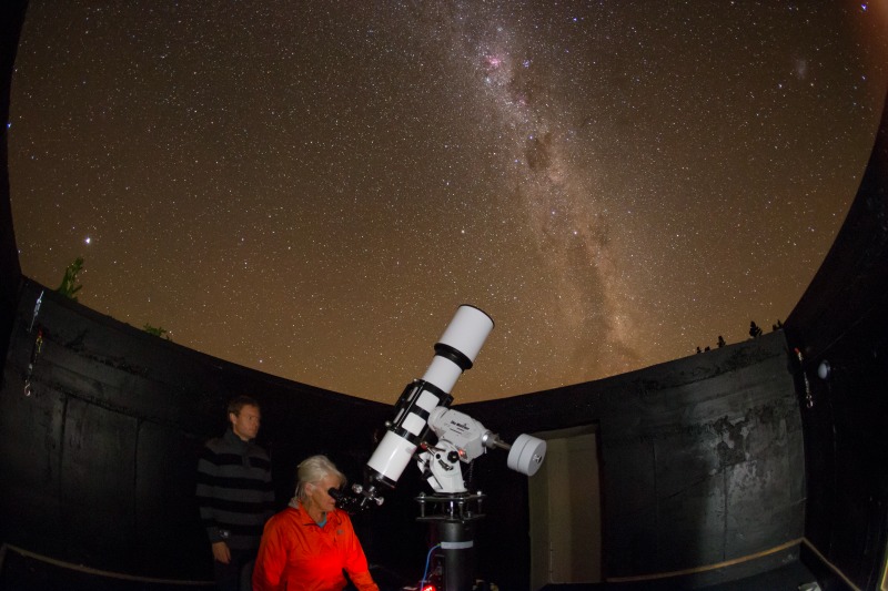 gazing through telescope pukaki wine cellar observatory